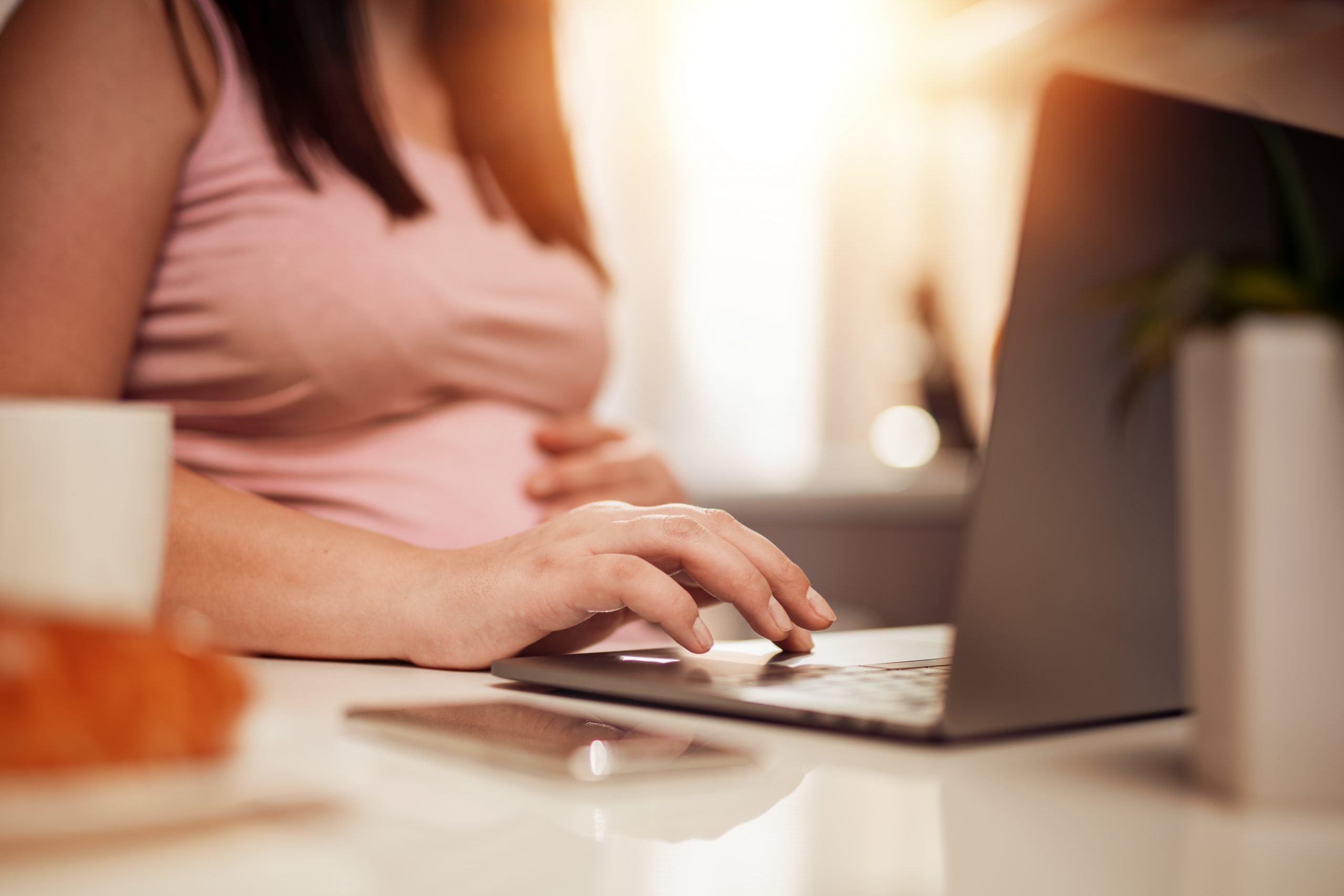 Pregnant woman using laptop